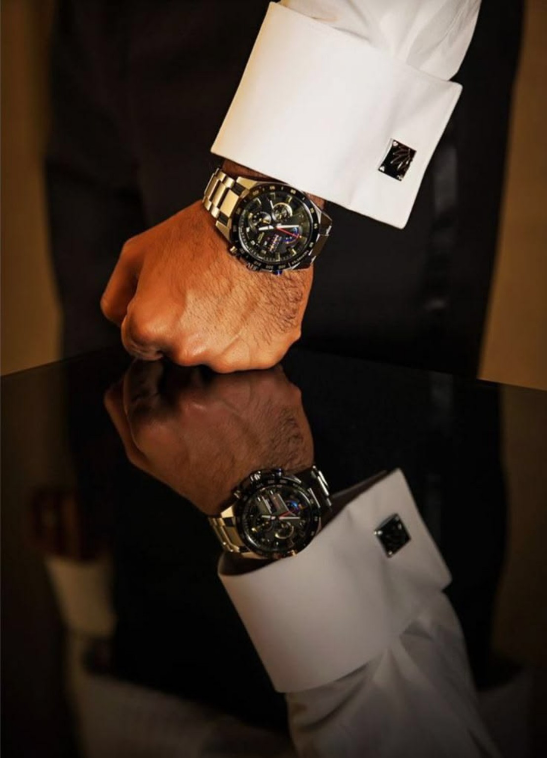 A man's cuff and watch at the meeting table