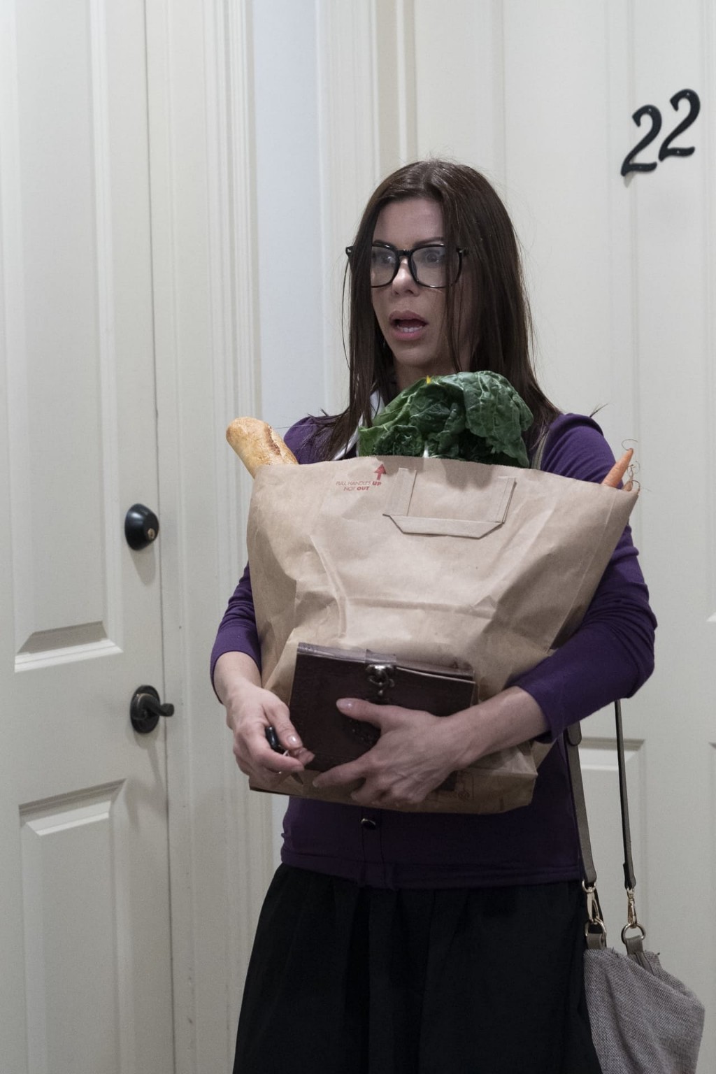 The protagonist's mother enters carrying a shopping bag