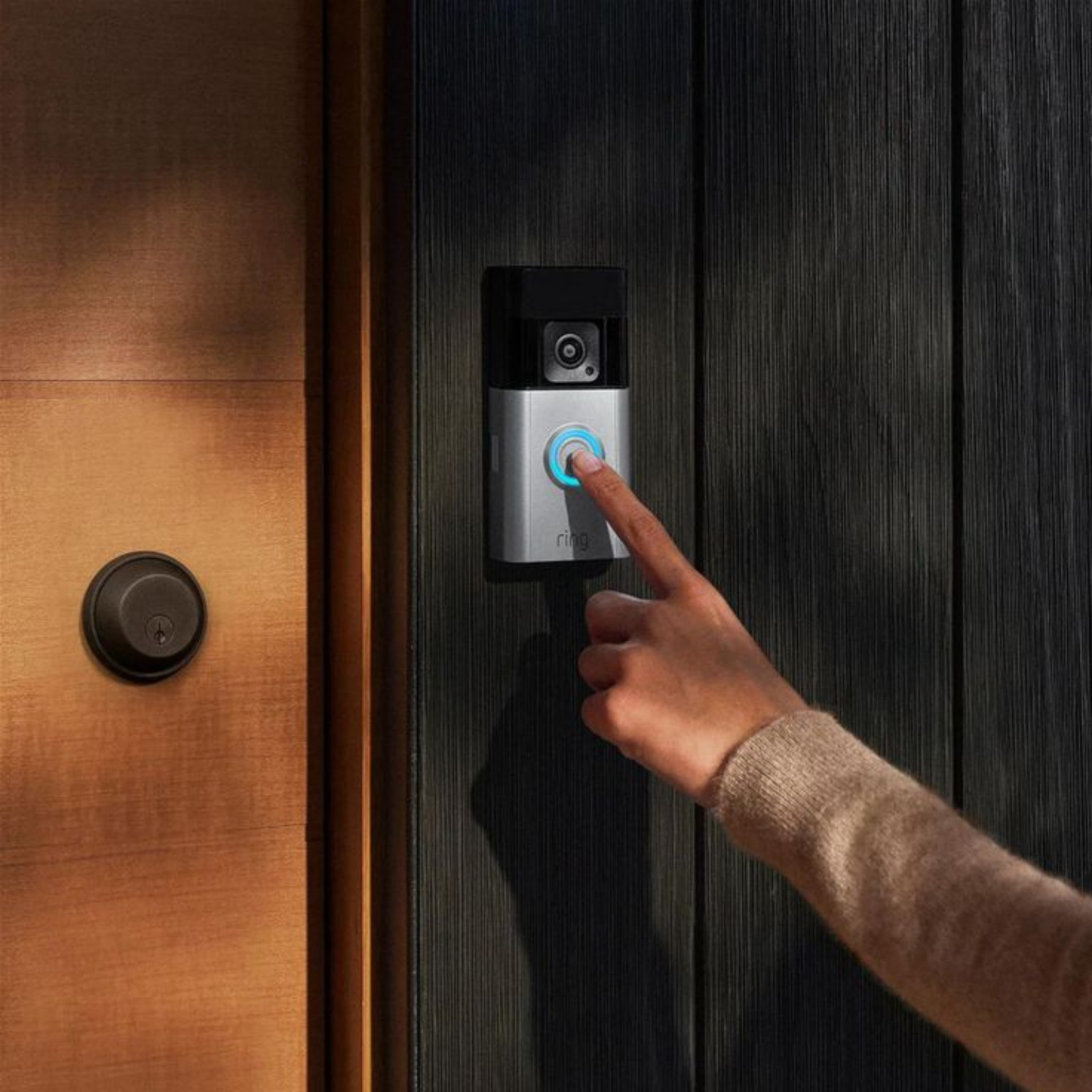 A finger pressing the doorbell