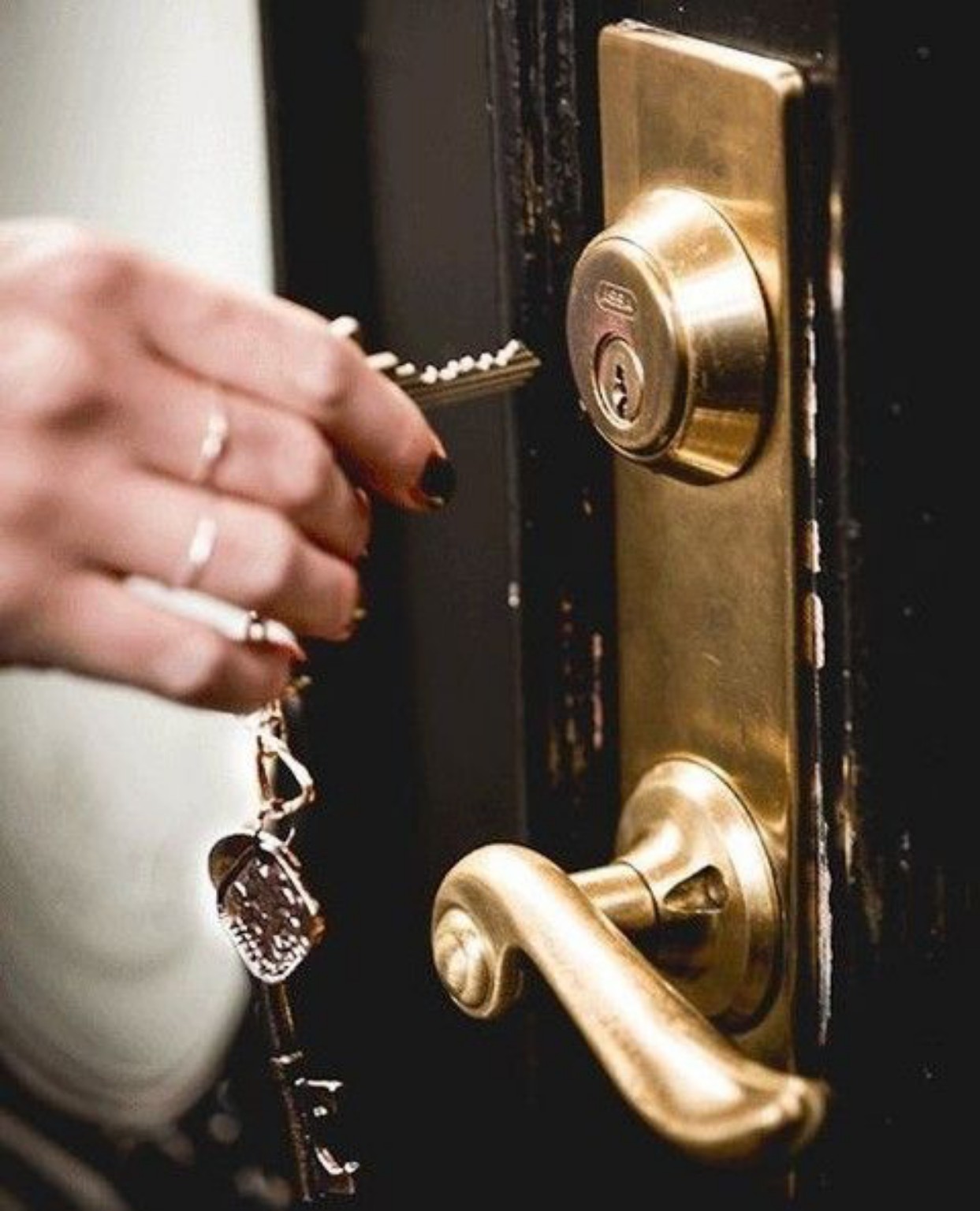 A hand unlocking a door