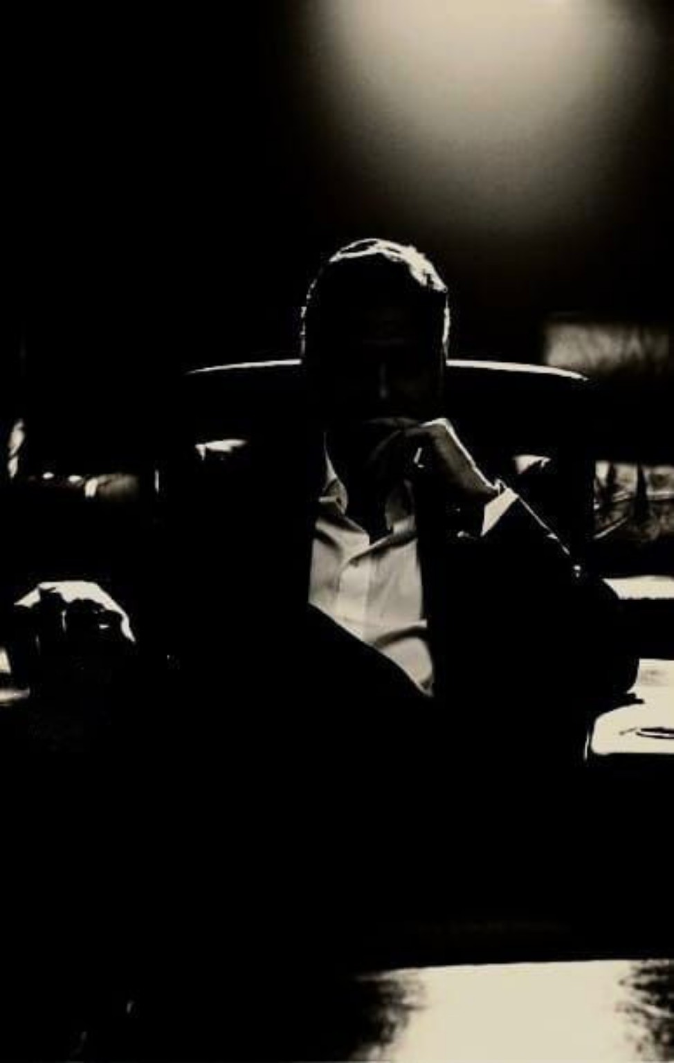 A mysterious man sitting in the darkness